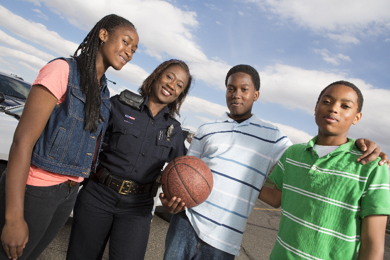 Black officer with black teens